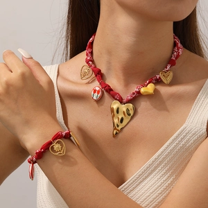 Red fabric flower heart pendant necklace and bracelet jewelry set on model