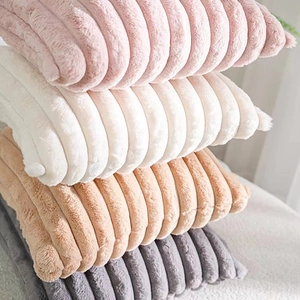 Faux rabbit fur throw pillows with ribbed texture in pink, cream, khaki, and grey