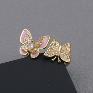 Macro shot of double butterfly open ring with pink enamel and sparkling zircon stones