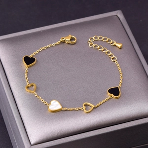 Minimalist stainless steel heart bracelet with black and white shell pendants on gold chain