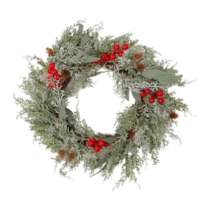 Artificial Christmas wreath with red berries, snowy pine needles and pine cones on rattan