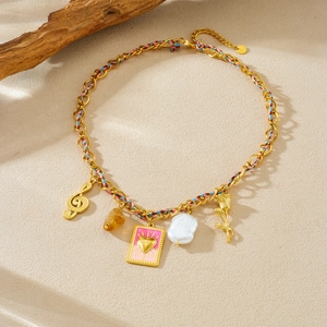 Colorful woven cord necklace with golden musical note, heart charm, and pearl pendant