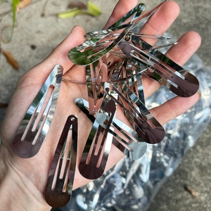 Close-up of bulk silver metal teardrop BB hair clips for DIY craft accessories
