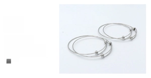 Detail view of four silver adjustable 304 stainless steel bangles for infants