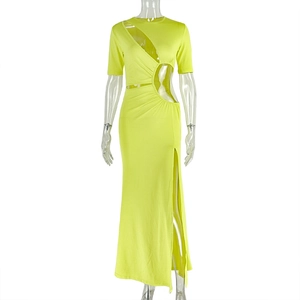 Detail view of waist cutout and side slit on the lime green slim-fit knit dress