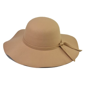 Close-up of wavy brim and elegant bow detail on a camel wool felt floppy sun hat
