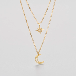 Double-layered gold star and moon necklace with sparkling crystals and elegant chain