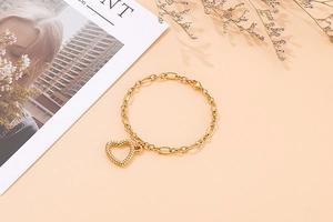 Detail of a vintage gold hollow heart pendant with twisted texture on a sleek chain
