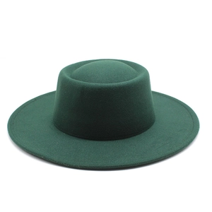 Detail of dark green wide-brim wool felt hat with flat top and precise edge stitching
