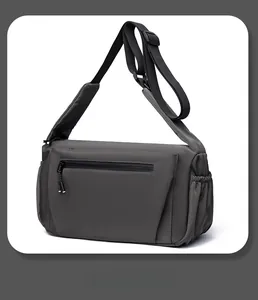 Detail of waterproof dark grey crossbody bag with wide padded strap and smart storage