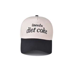 Detailed embroidery of 'ineeda diet coke' on a two-tone cotton baseball cap with black brim
