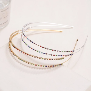 Detail of four thin double-layer headbands with colorful rhinestones on gold and silver metal