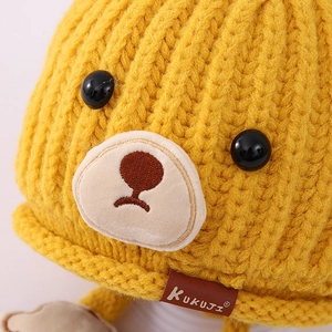 Kids warm knit winter beanie in yellow with cute cartoon bear face and ear protection