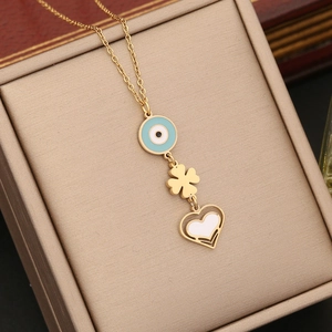 Golden necklace with blue evil eye, clover, and heart charms in a luxury jewelry box