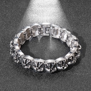 Macro shot of vintage skull and cross link bracelet with stainless steel engraving