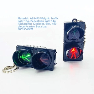 Detailed view of mini traffic light keychain with glowing LED pedestrian signal and bead chain
