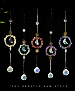 Detail of five multi-colored crystal suncatchers with gold metal moon and prisms