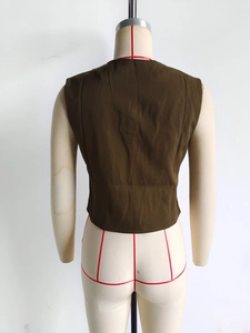 Back view of asymmetrical olive green tank top vest showing its cut and silhouette