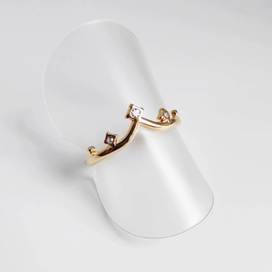 Detailed close-up of a 18K gold-plated V-shaped crown ring with three inlaid zircons