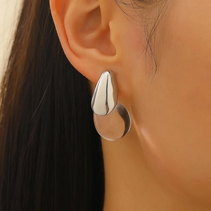 Macro view of minimalist layered teardrop earrings with silver metal and clear resin details