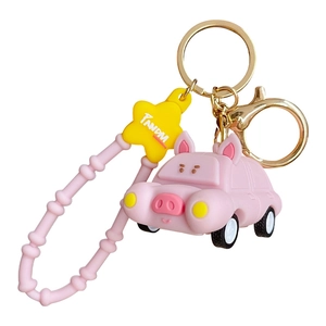 Pink cartoon pig pull-back car keychain with yellow star charm and gold metal ring