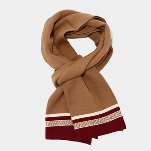 Detail of camel knit scarf with burgundy stripes and geometric jacquard texture