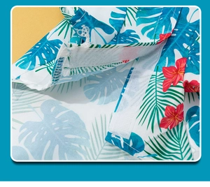 Close-up of tropical palm print dog shirt featuring easy hook and loop velcro closure