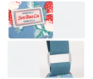 Detail of printed canvas bag showing brand woven label and silver metal buckle hardware