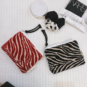 Zebra pattern mini makeup pouch in red and black jacquard fabric with zipper