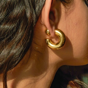 Polished gold thick C-shaped hoop earrings for women with a modern metallic finish