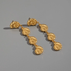 Close-up of 18K gold plated stainless steel earrings with triple shell tassel design
