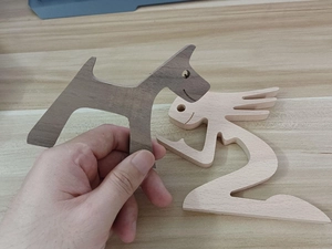 Detailed close-up of a handcrafted wooden dog and human figurine for home decor