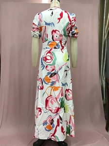 Detail view of colorful graffiti print on white chiffon maxi dress with silky texture