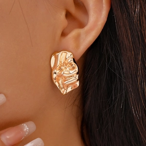 Irregular gold crumpled earrings with molten metal texture in a minimalist geometric style