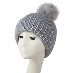 Women's grey knitted beanie with warm fleece lining, colorful rhinestones, and faux fur pompom