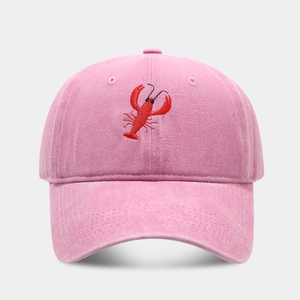 Close-up of a red lobster embroidery on pink washed cotton vintage baseball cap