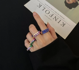 Close-up of stacked 925 silver rings with multi-colored 5A zircons on a model hand