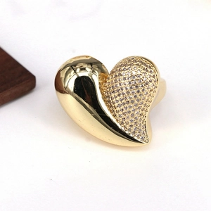 Macro shot of 18k gold plated heart ring featuring one side paved with clear crystals