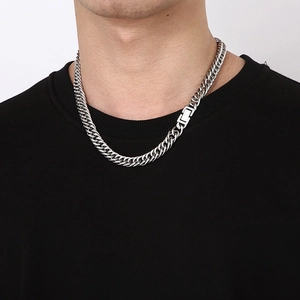 Detail view of silver cuban link chain necklace with a unique rectangle buckle on model
