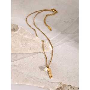 Detailed view of the 18k gold stainless steel MAMA pendant necklace with freshwater pearl