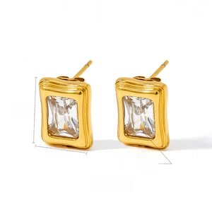 Detailed view of rectangular gold-plated stud earrings with square-cut cubic zirconia crystals