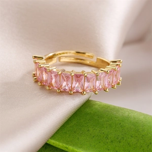 Elegant gold-plated ring featuring pink rectangular zircon stones on pink satin fabric