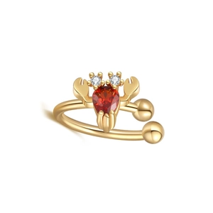 Detailed macro view of golden lobster ear cuff featuring a pear-cut red zircon stone