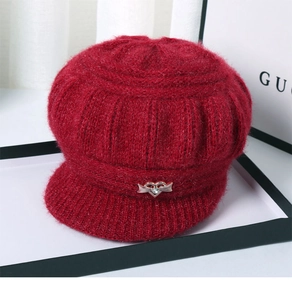Detail of red knit beret with fuzzy texture and silver heart rhinestone buckle for women