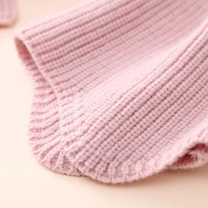 Macro shot of pink ribbed knit texture showing the warm material and fabric detail