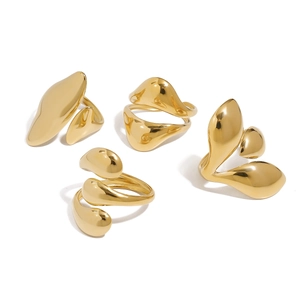 Set of four gold irregular teardrop rings with polished liquid metal finish on white background