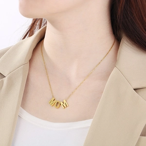 Golden MOM heart pendant necklace with opal shown on a model neck in close-up shot