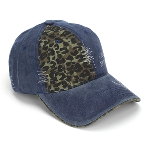 Detailed view of washed denim baseball cap with leopard patch and zigzag stitching