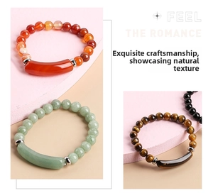 Detail of natural stone beaded bracelet with polished curved tube bead and metal spacers
