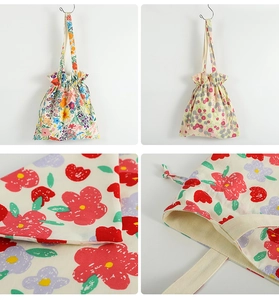 Detail of floral canvas drawstring bag showing fabric texture and drawstring closure